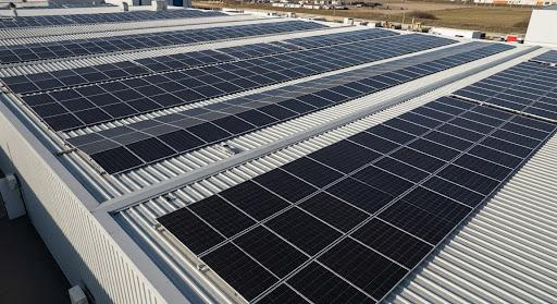 Commercial solar panel installation on a large roof