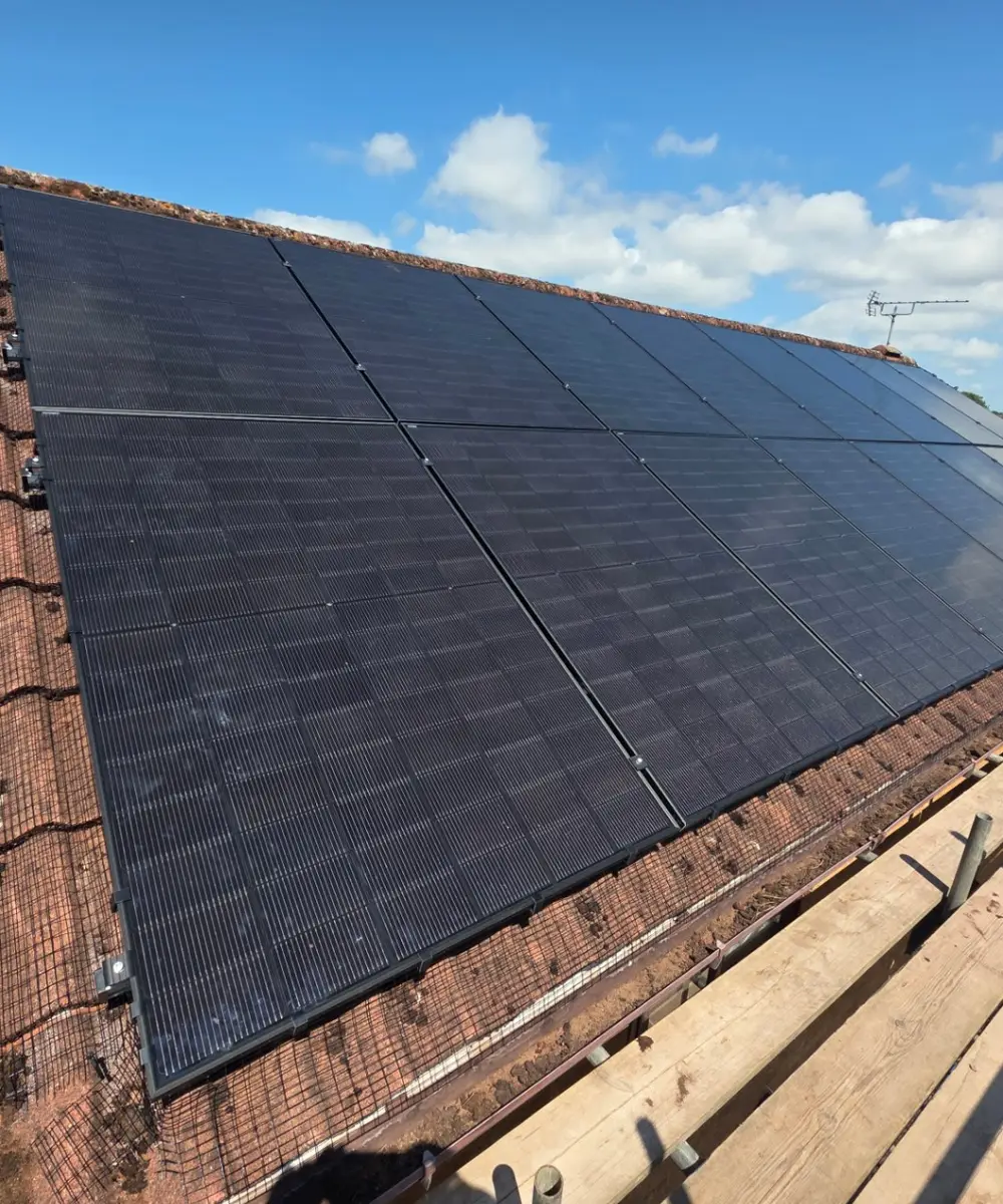 All-black solar panel array on a tiled roof