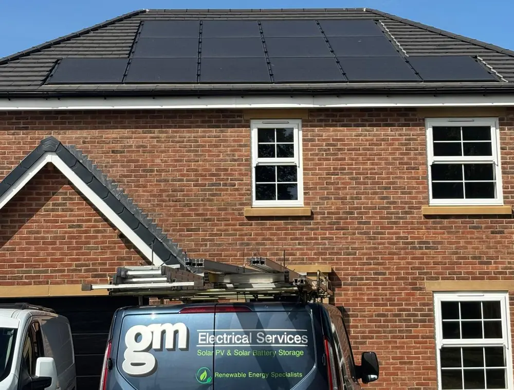 In-roof solar panels on a new-build home, with the GM Electrical Services van outside